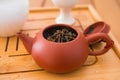 Beautiful brown clay teapot on a bamboo tray Royalty Free Stock Photo