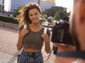 Beautiful brown curly hair woman posing in city Royalty Free Stock Photo