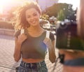 Beautiful brown curly hair woman posing in city Royalty Free Stock Photo