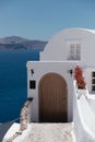 Beautiful brown door on white facade of greek architecture hotel in Oia city, Santorini island, Greece, Europe. Royalty Free Stock Photo