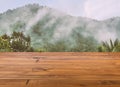 Beautiful brown plank wooden table or desk floor, little shiny surface, perspective view, the background of a blurred mountain Royalty Free Stock Photo