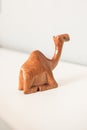 Beautiful brown varnished wooden dromedary camel miniature sitting down