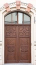 Beautiful brown vintage doors on the white house facade