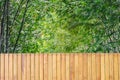 Beautiful brown wooden door decoration and blurred bamboo garden in background. A simple beautiful plank fence wall with bamboo. Royalty Free Stock Photo