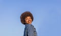 Beautiful brunette with afro hair with prefect smile and very white teeth that shows happy a sunny day Royalty Free Stock Photo