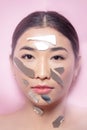 Beautiful brunette asian woman fashion portrait with makeup fake eyelash shards of broken mirror on his face Royalty Free Stock Photo