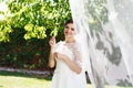 Beautiful brunette bride with bouquet outdoor. Happy bride outdo Royalty Free Stock Photo