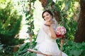 Beautiful brunette bride with bouquet outdoor. Happy bride outdo Royalty Free Stock Photo