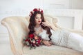 Beautiful brunette Bride lying on Classic elegant sofa, baroque