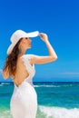 Beautiful brunette bride in white wedding dress and straw hat ha Royalty Free Stock Photo