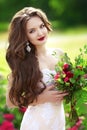 Beautiful brunette bride woman with wedding bouquet of flowers a Royalty Free Stock Photo