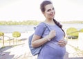 Beautiful brunette caucasian pregnant woman on summer walk outdo Royalty Free Stock Photo