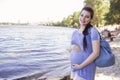 Beautiful brunette caucasian pregnant woman on summer walk outdo Royalty Free Stock Photo