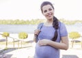 Beautiful brunette caucasian pregnant woman on summer walk outdo Royalty Free Stock Photo