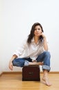 Beautiful brunette sitting on the coffer.