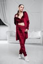 Beautiful brunette dressed in a burgundy velor suit