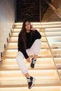 Young beautiful brunette fashion model posing on stairs. Royalty Free Stock Photo