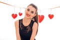 Beautiful brunette girl in black dress with nice make up celebrate Valentines day with red heart in studio isolated on Royalty Free Stock Photo