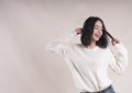 Beautiful brunette girl braces happy white sweater, dancing, emotion Royalty Free Stock Photo