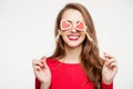 Beautiful brunette girl closed her eyes with two hearts of souvenirs. Valentine`s day concept. On white background. Place for tex Royalty Free Stock Photo