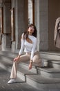 beautiful brunette girl dressed in white blouse, pants and sneakers. Stylish trendy fashion outlook Royalty Free Stock Photo