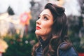 Woman with hairstyle and makeup looks up at New Year`s Square