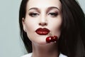 Beautiful girl with cherries in her mouth Royalty Free Stock Photo