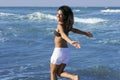 Beautiful brunette girl jumping on the beach Royalty Free Stock Photo