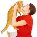 Beautiful brunette girl kissing a red cat