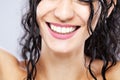 Beautiful brunette girl with long wet hair, abstract closeup studio portrait. Smiling face expression. Big smile with white teeth Royalty Free Stock Photo