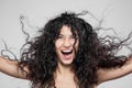 Beautiful brunette girl with long wet hair, studio portrait. Very happy smiling expression