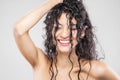 Beautiful brunette girl with long wet hair, studio portrait. Very happy smiling expression