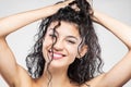 Beautiful brunette girl with long wet hair, studio portrait. Very happy smiling expression