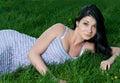 Beautiful brunette girl lying in grass.