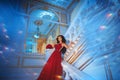 Beautiful girl in a red ball gown in palace interiors Royalty Free Stock Photo