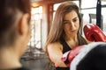 Beautiful brunette girl with red gloves exercising kick boxing at gym. Royalty Free Stock Photo