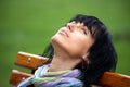 Beautiful brunette girl resting in a park bench Royalty Free Stock Photo