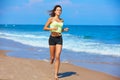 Beautiful brunette girl running in a summer beach Royalty Free Stock Photo