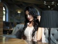 Beautiful brunette girl sitting at a table in a restaurant and looking at the camera Royalty Free Stock Photo