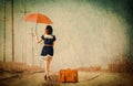 Brunette girl with suitcase and umbrella Royalty Free Stock Photo