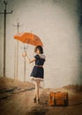 Brunette girl with suitcase and umbrella Royalty Free Stock Photo