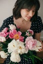 Beautiful brunette girl in vintage dress holding modern bouquet with pink and white peonies. Happy stylish woman with peony Royalty Free Stock Photo