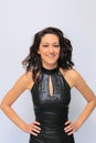 Beautiful brunette girl wearing black faux leather dress