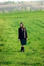 Beautiful brunette girl in windy green field, sunny springtime, Royalty Free Stock Photo