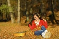 Beautiful brunette guitar player girl in the forest Royalty Free Stock Photo