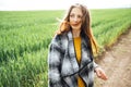 Beautiful brunette lady in wheat field at sunset. Happy beautiful woman in meadow. Royalty Free Stock Photo