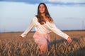 Beautiful brunette lady in wheat field at sunset Royalty Free Stock Photo