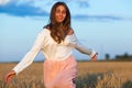 Beautiful brunette lady in wheat field at sunset Royalty Free Stock Photo