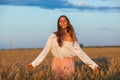 Beautiful brunette lady in wheat field at sunset Royalty Free Stock Photo