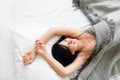 Beautiful brunette laughing in bed top view Royalty Free Stock Photo